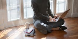 woman in gray sweat shirt sitting beside window 3759080